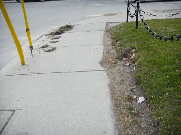 Repeated plow damage. Fresh evidence remains on the sidewalk.