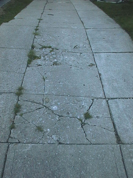 The original driveway before removal of middle section. Cracked concrete was replaced with pavers.