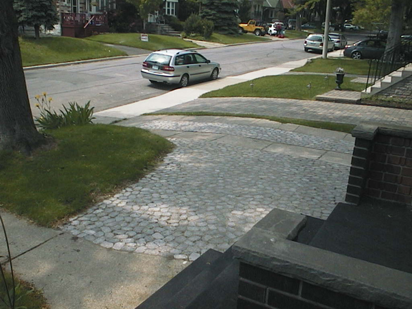 The new driveway (widening and middle section of main drag) with pavers replacing lawn and concrete slabs, respectively.
